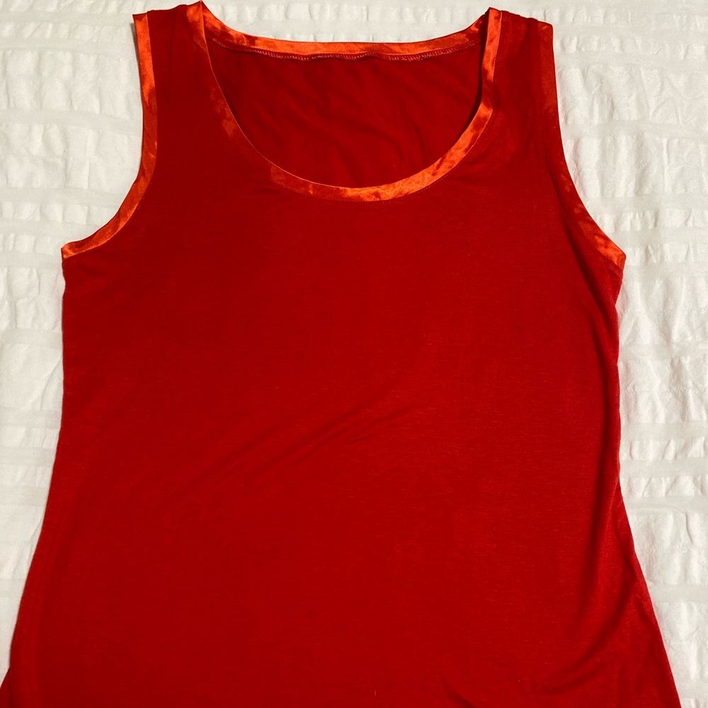 Orange sleeveless round neck top.